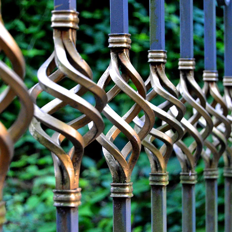 Ornamental steel railings with twisted basket balusters in a bronzed finish