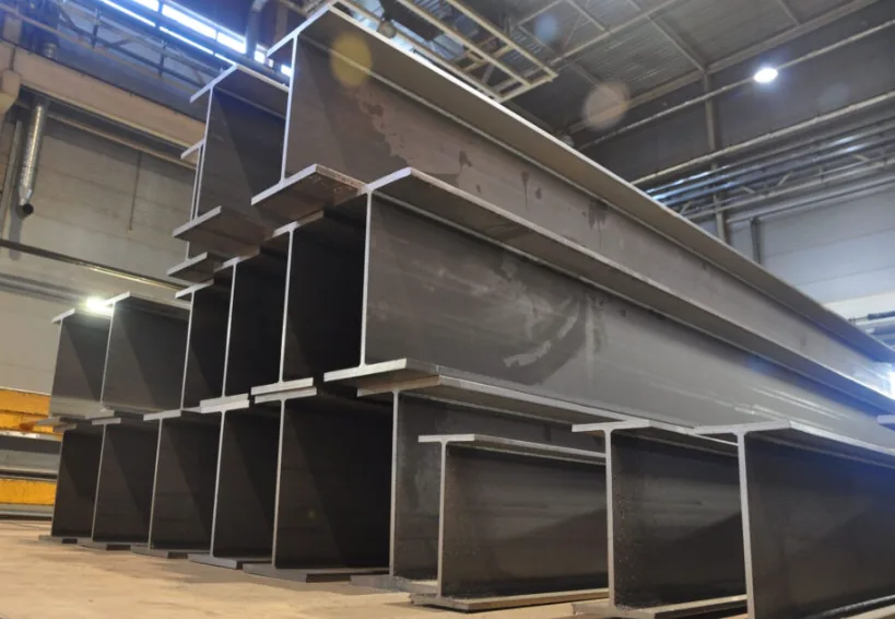 Stacked universal steel beams in the fabrication workshop